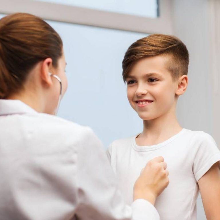 medicine-health-care-and-people-concept-female-doctor-or-nurse-with-stethoscope-listening-to-happy-child-chest-in-hospital